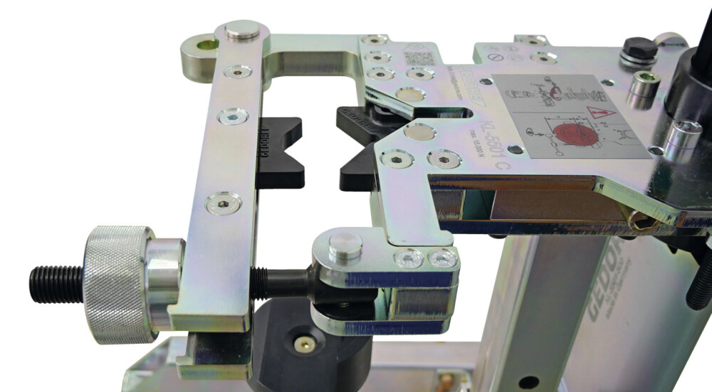 Stationary spring compressor